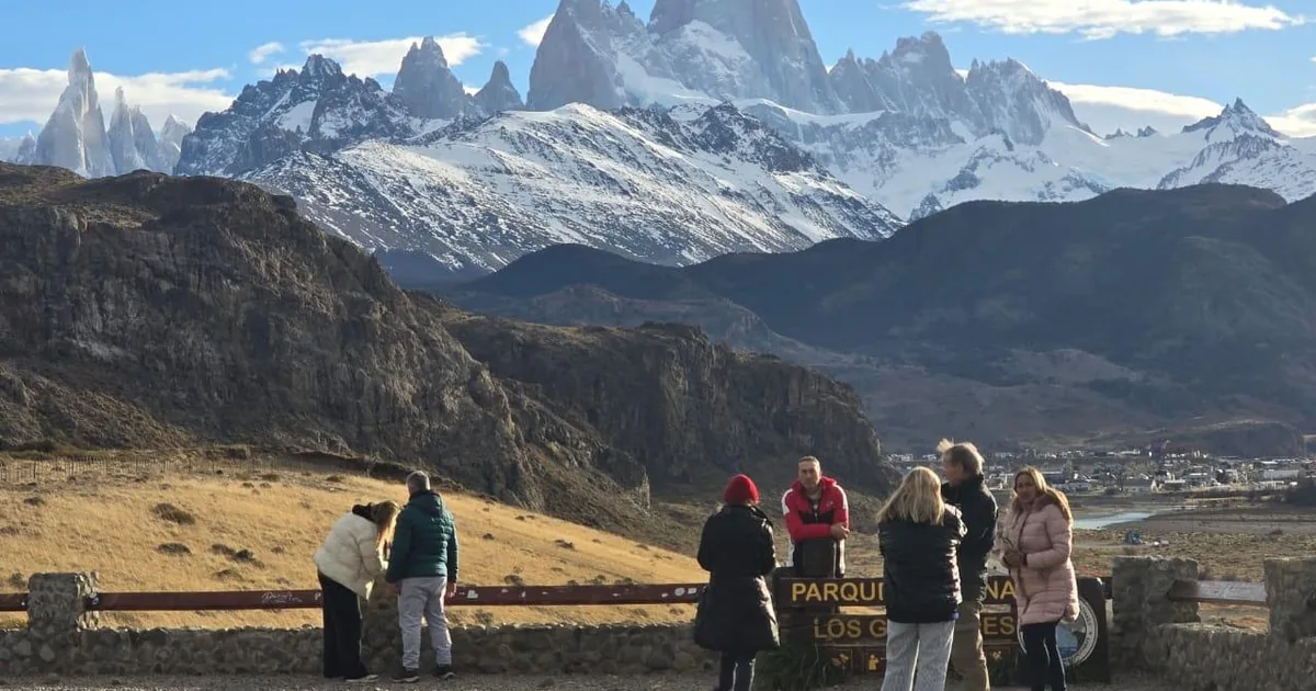 A group of visitors at a viewpoint facing Fitz Roy